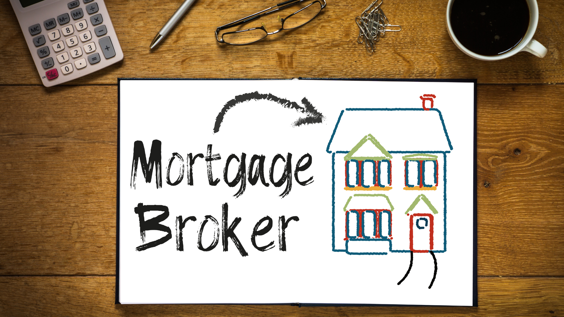 Mortgage Broker sign with house drawing on desk, with calculator, glasses, pen and coffee.