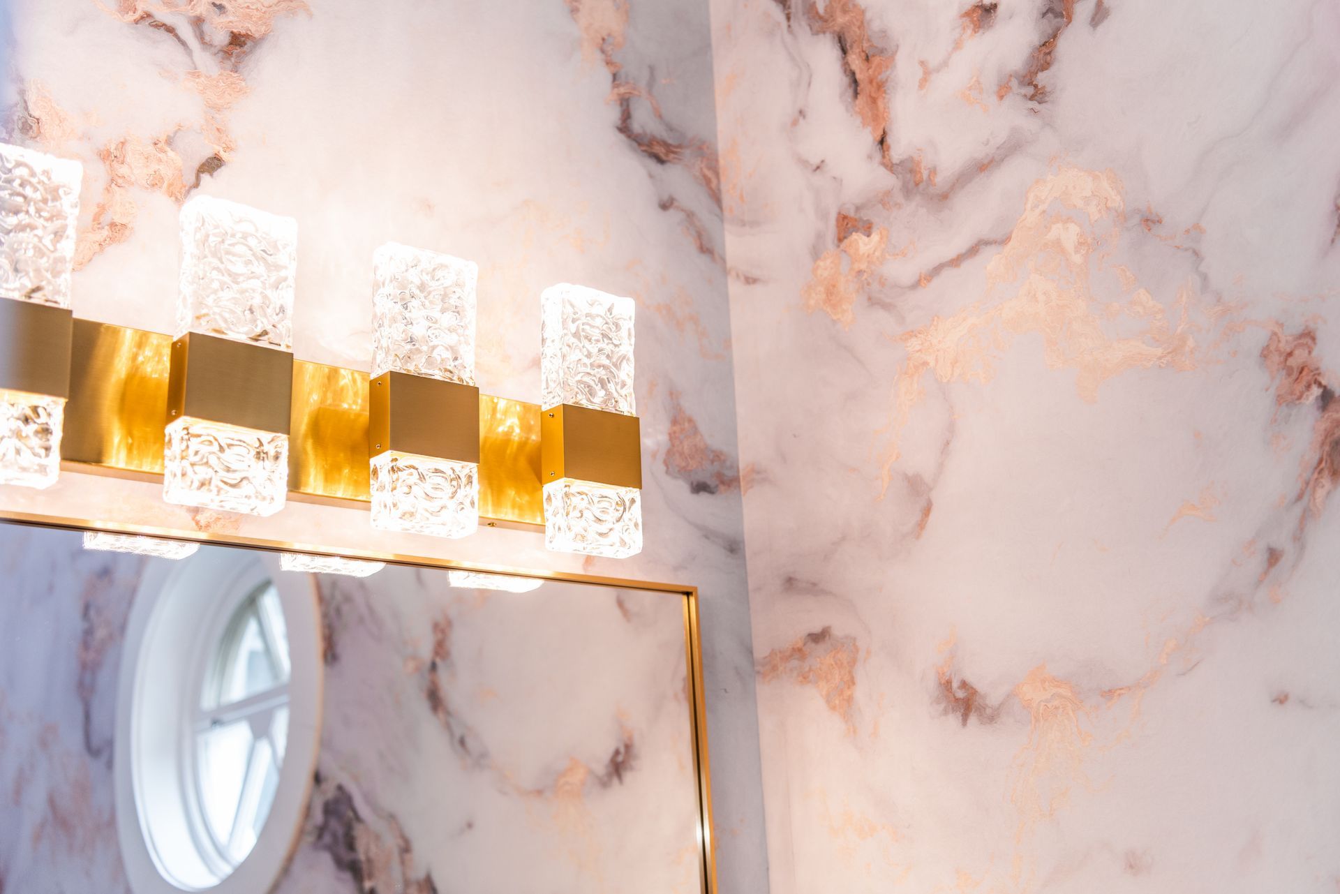 a bathroom with a marble wall and a mirror .