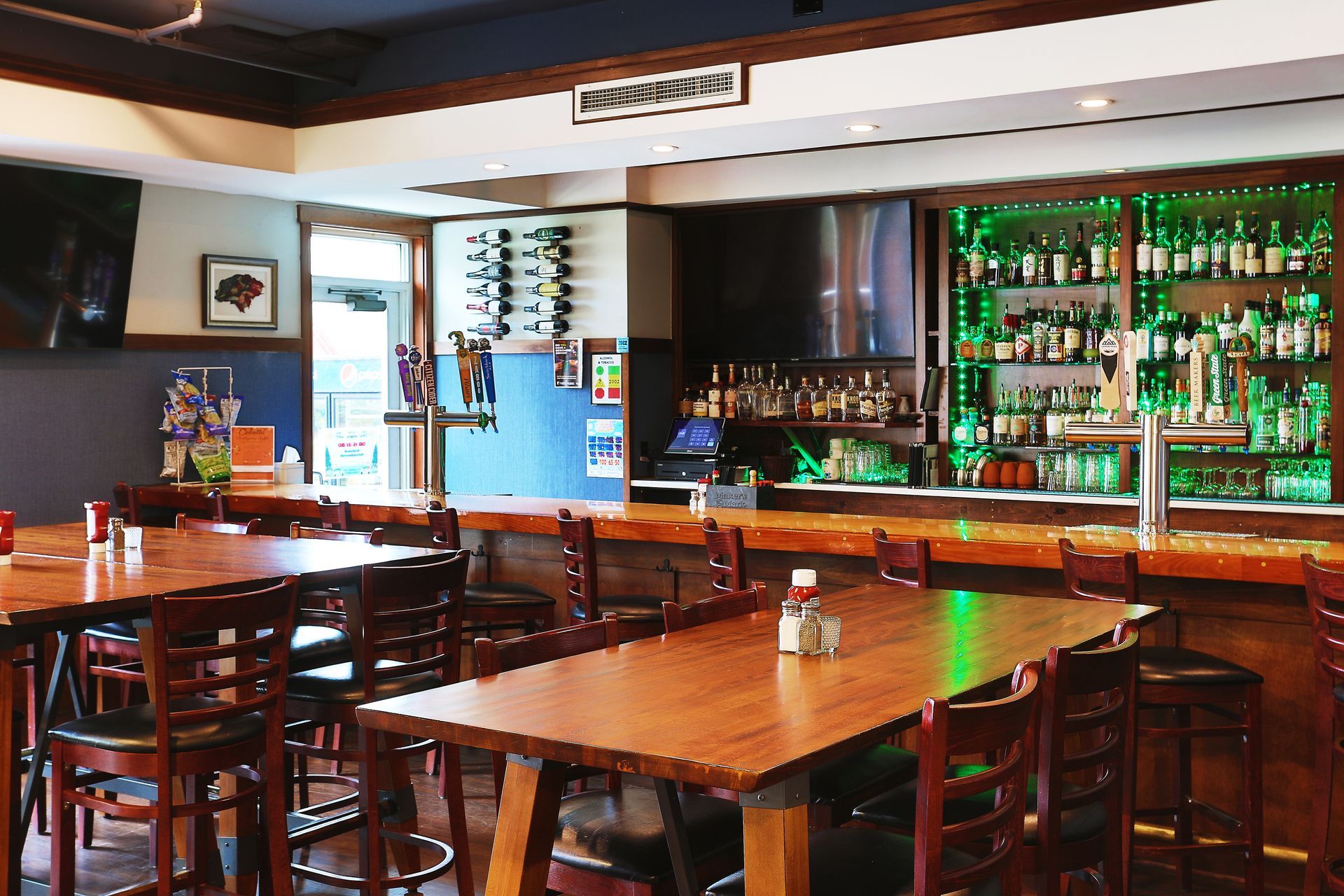 A restaurant with tables and chairs and a bar