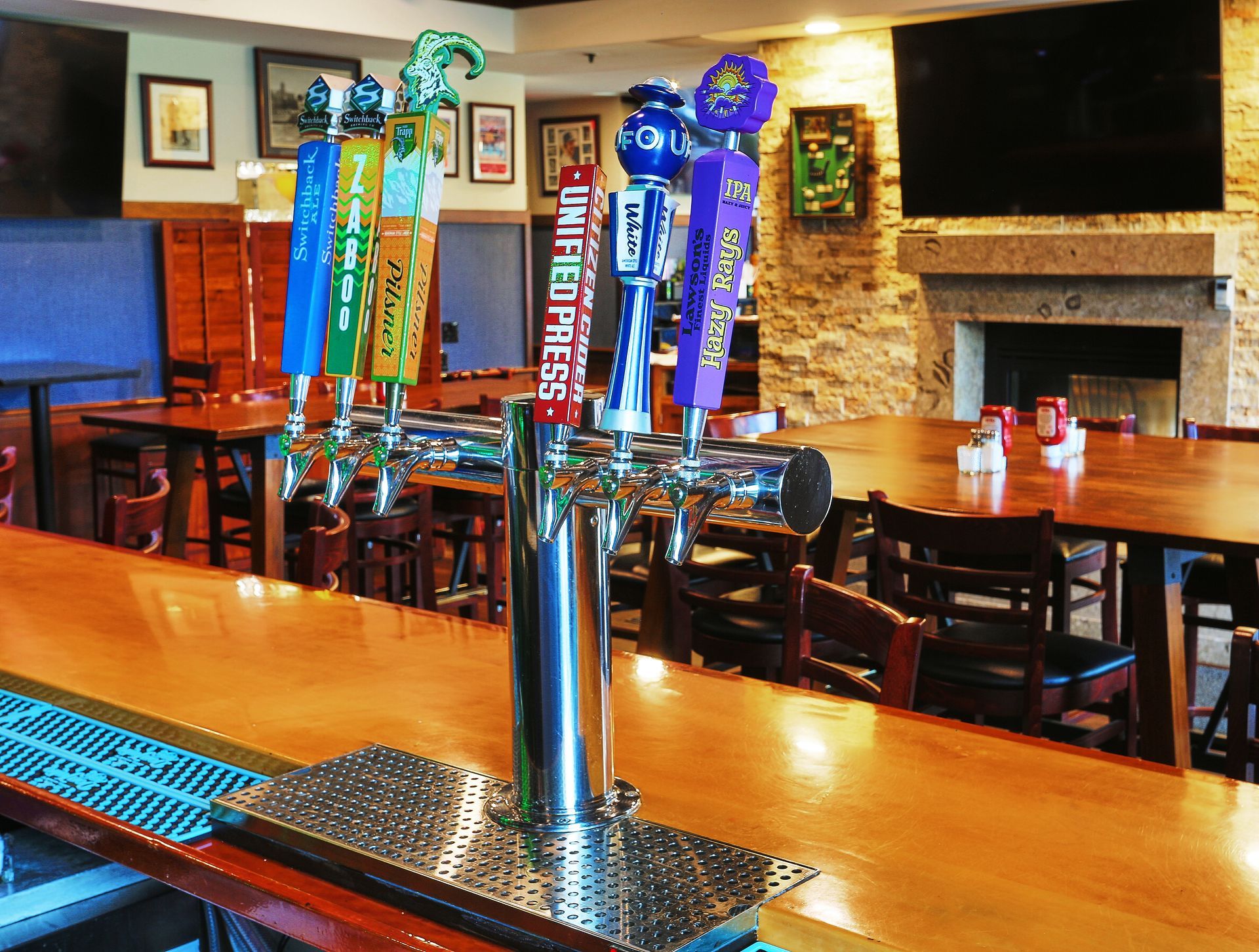 A row of beer taps including one that says purple