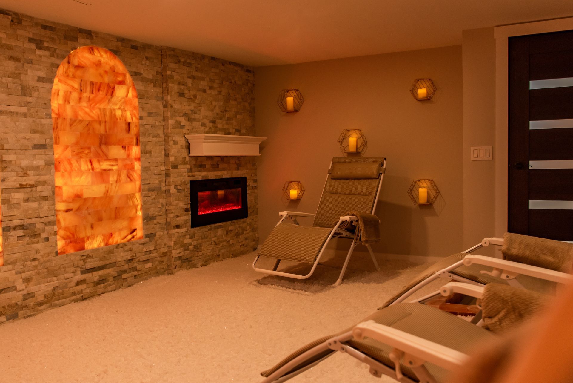 a room with a fireplace and chairs in it .