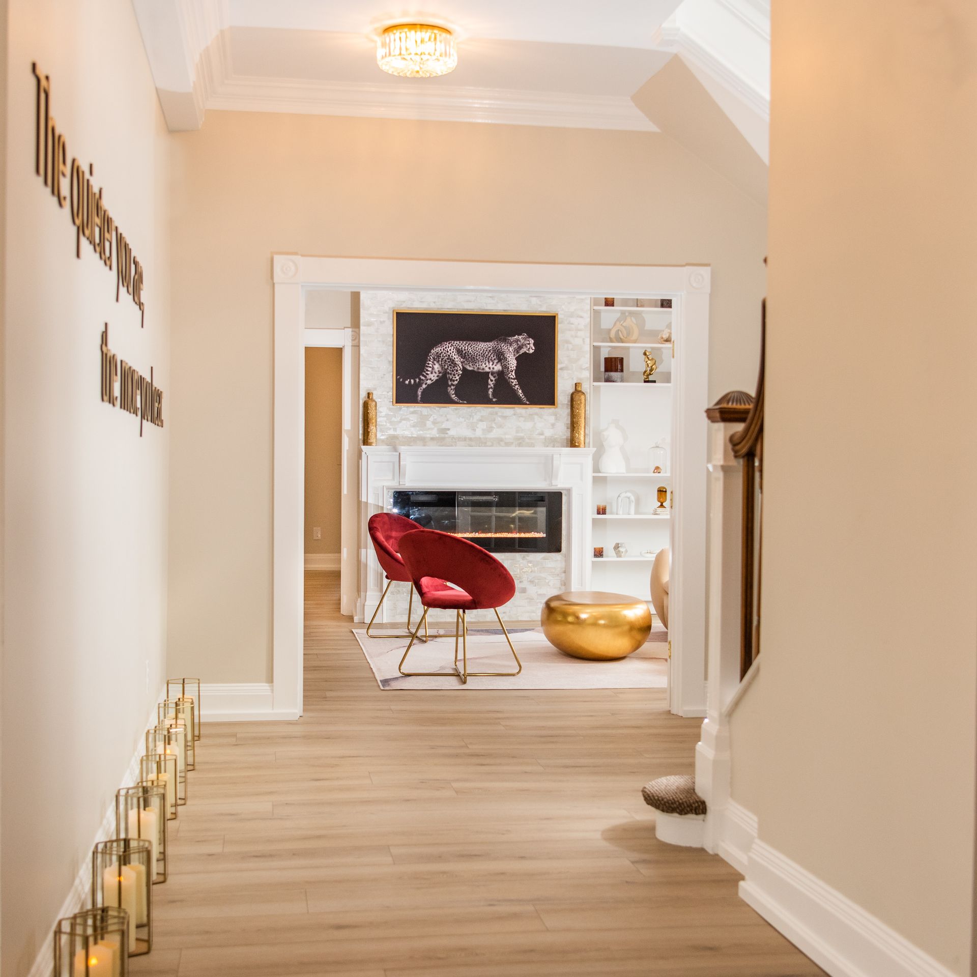 a hallway leading to a living room with candles on the floor