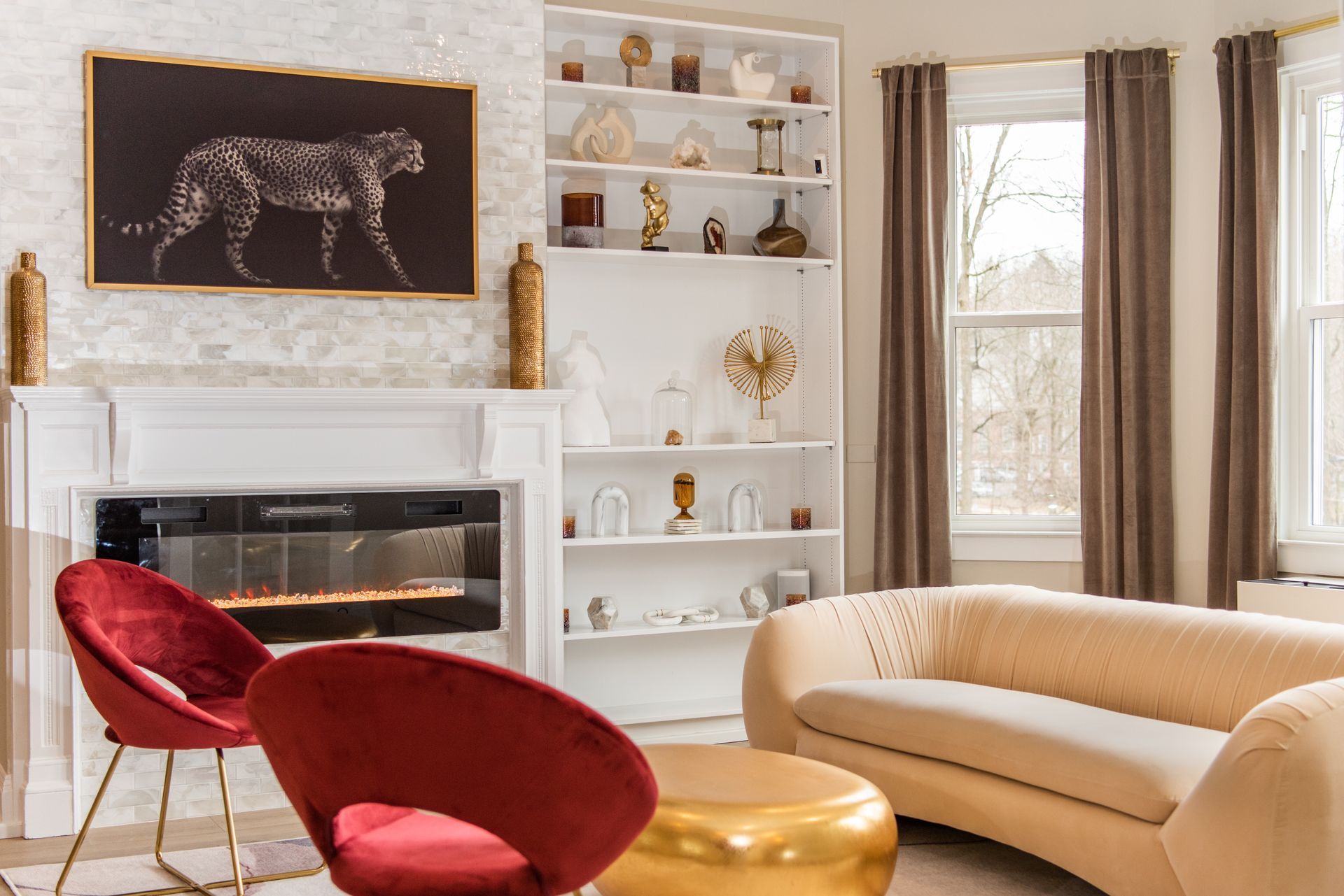 a living room with a couch , chairs , and a fireplace .