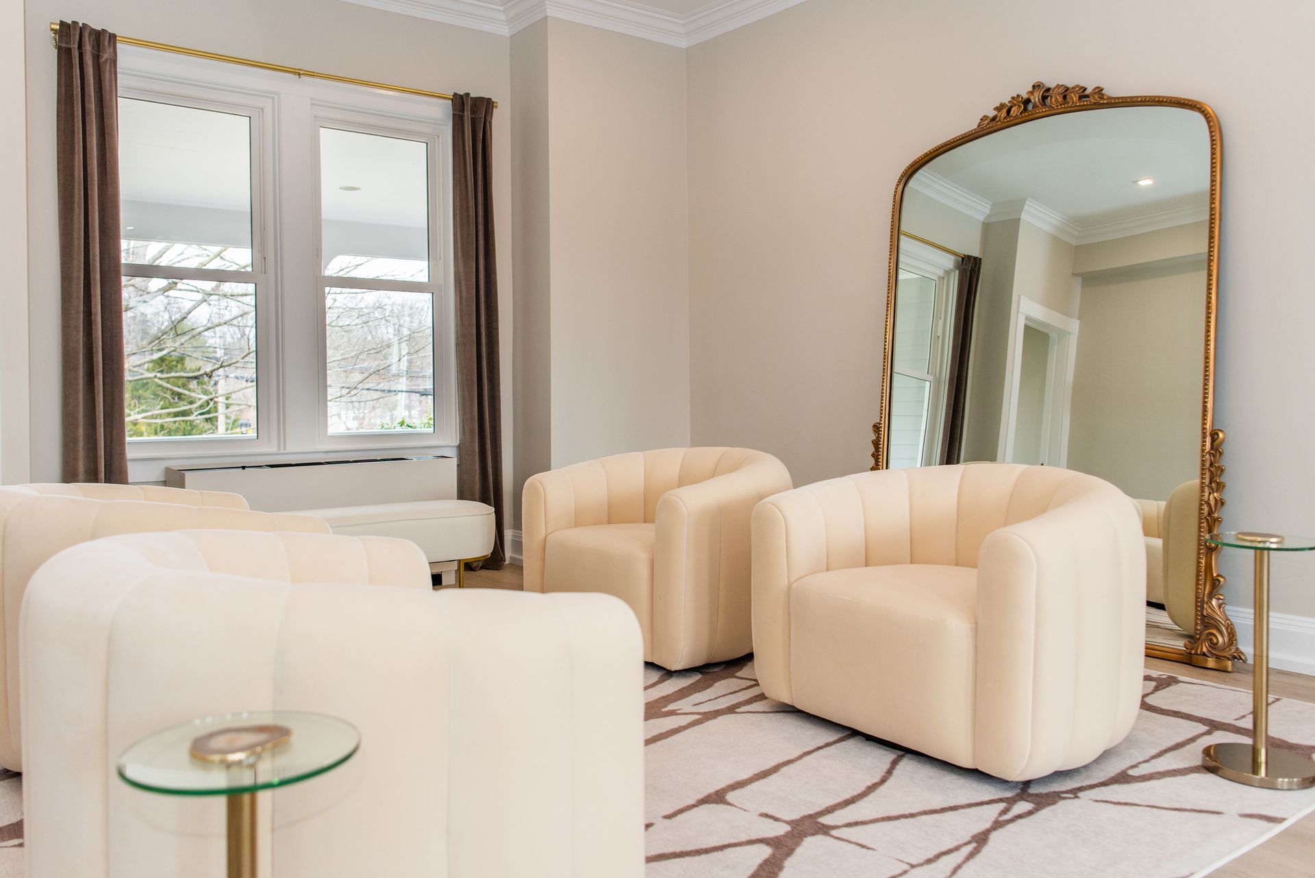 a living room with two chairs and a large mirror .