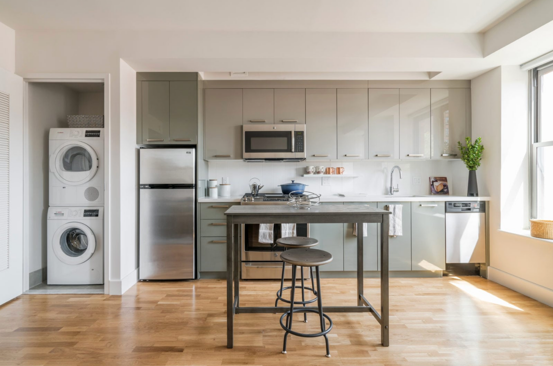 a kitchen with a washer and dryer stacked on top of each other .