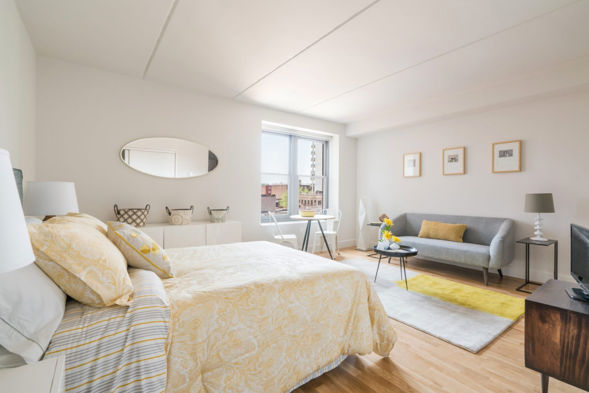 a bedroom with a bed , couch , and television .