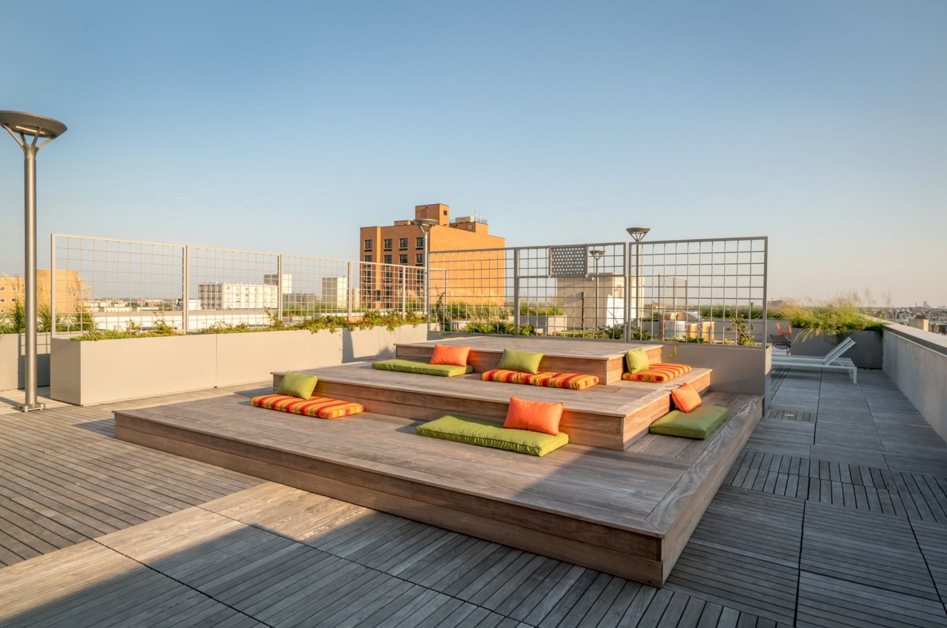 a rooftop deck with a lot of cushions on it .