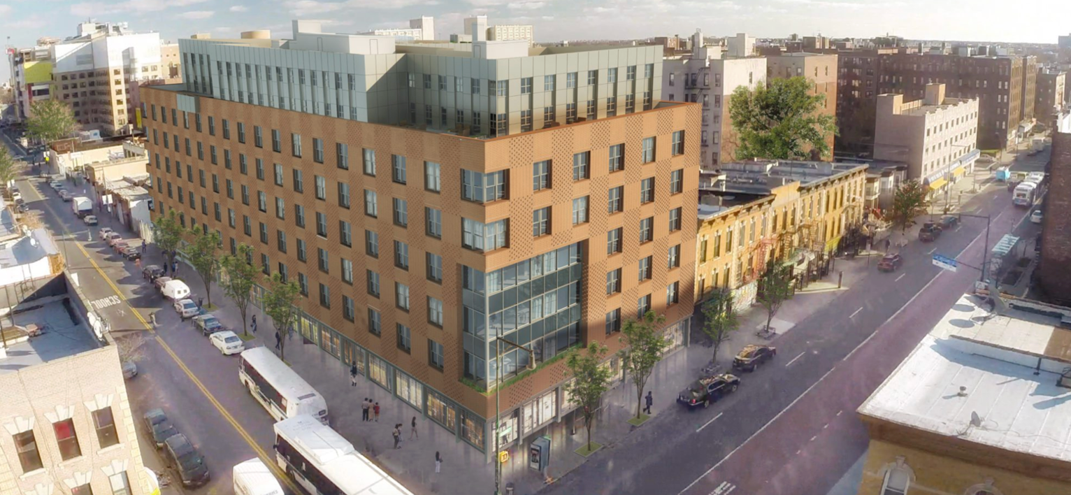 an aerial view of a large brick building in the middle of a city .
