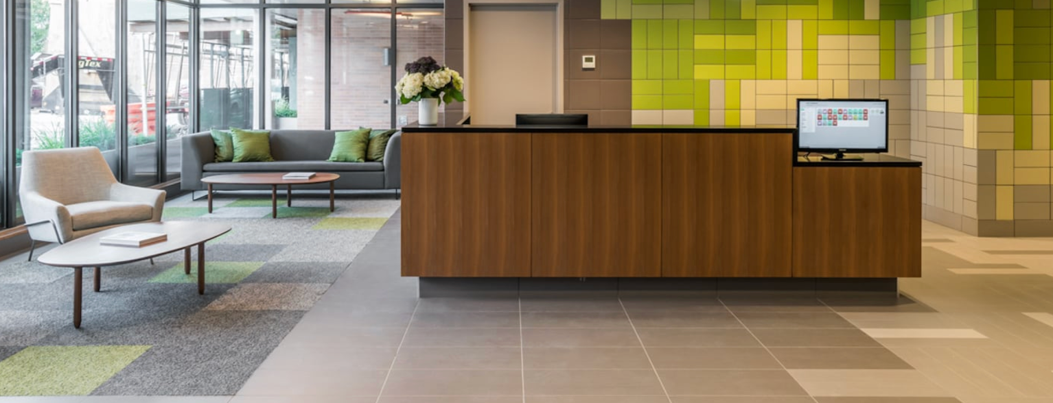 a lobby with a wooden counter and a computer on it .