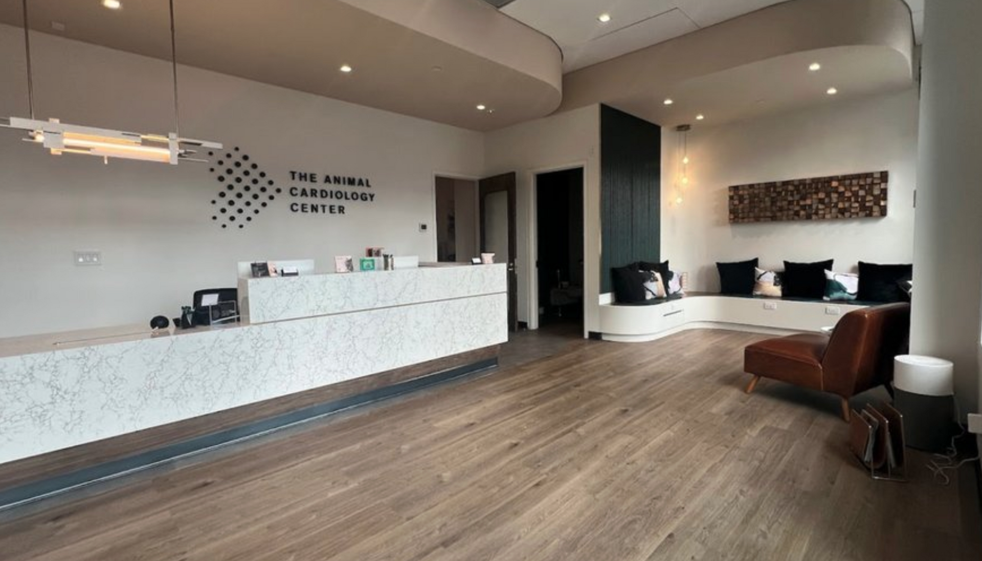 A lobby with a reception desk , chairs , and a couch.