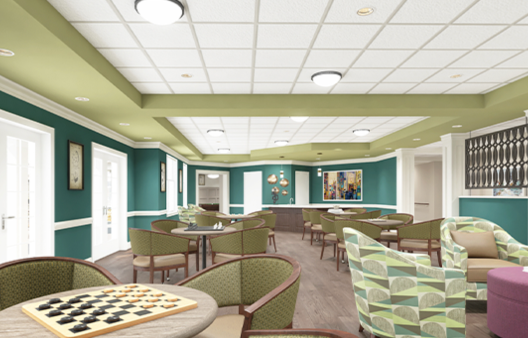 A large room with tables and chairs and a chess board on a table