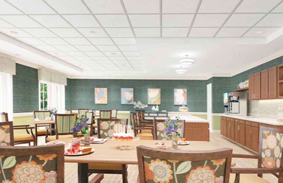 A large dining room with tables and chairs and a kitchen