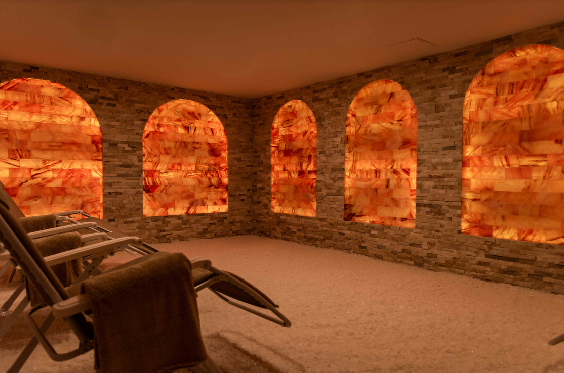 a room with a lot of windows and chairs in it .