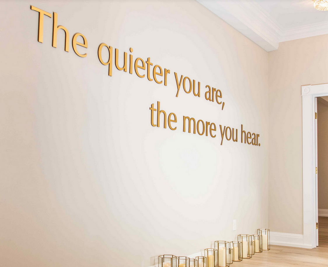 a wall with a quote on it that says `` the quieter you are , the more you hear ''