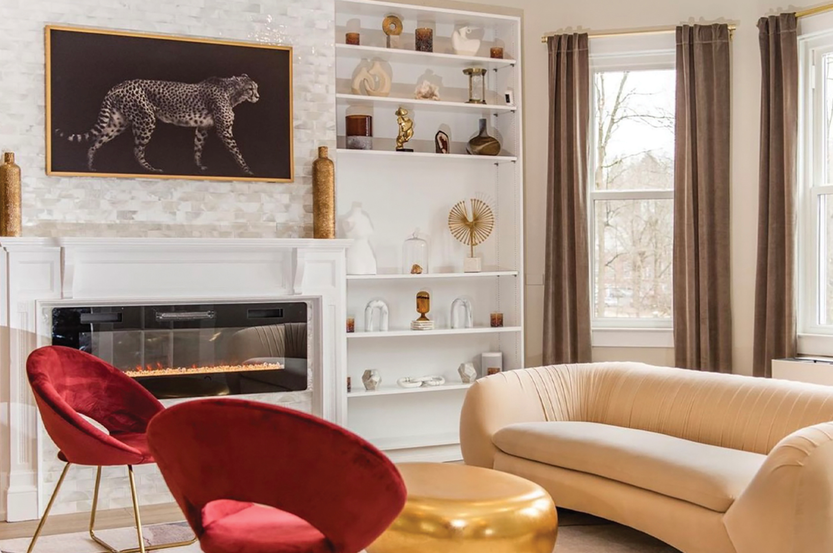 a living room with a couch , chairs , and a fireplace .