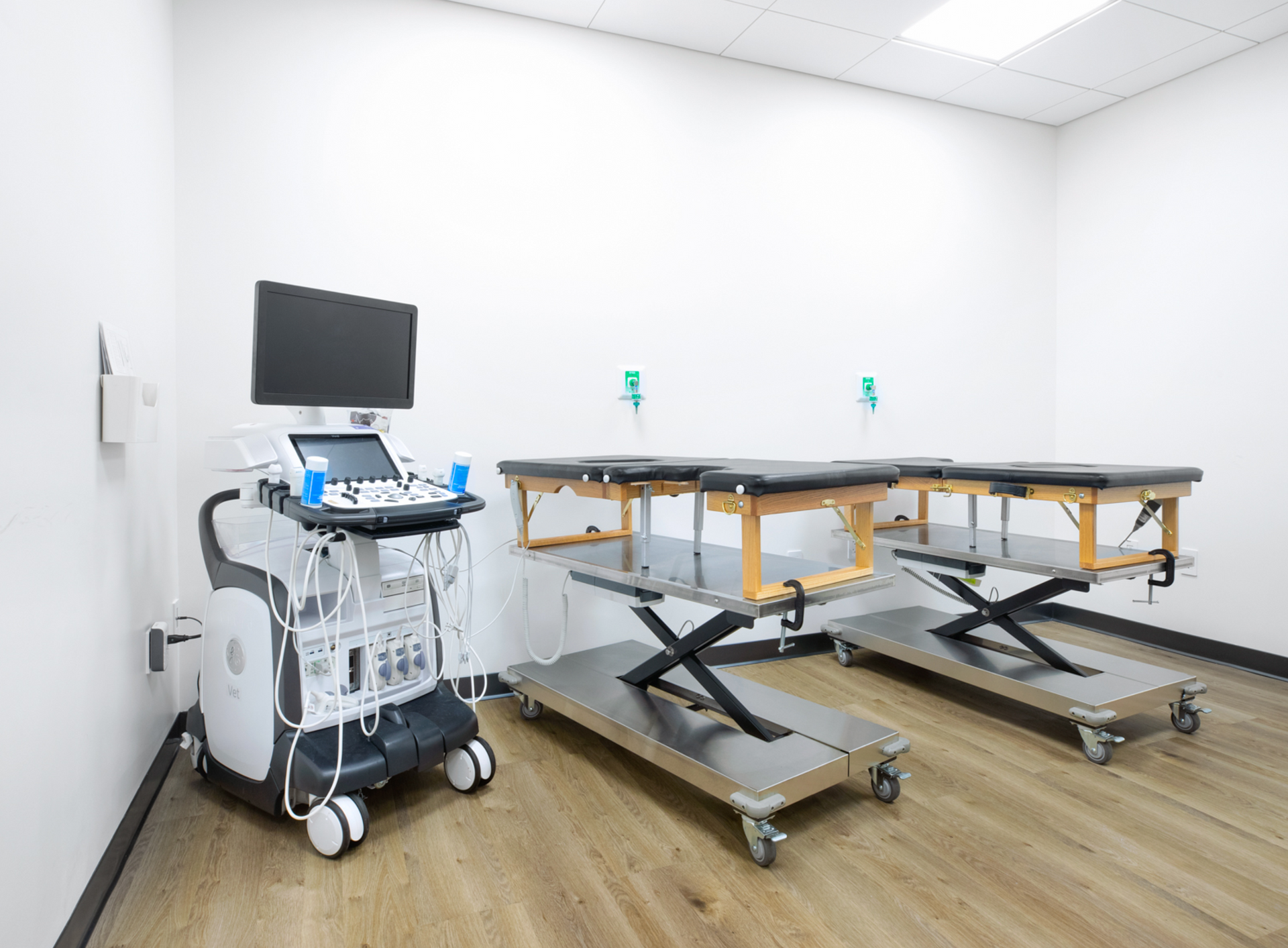 A room with two tables and an ultrasound machine.