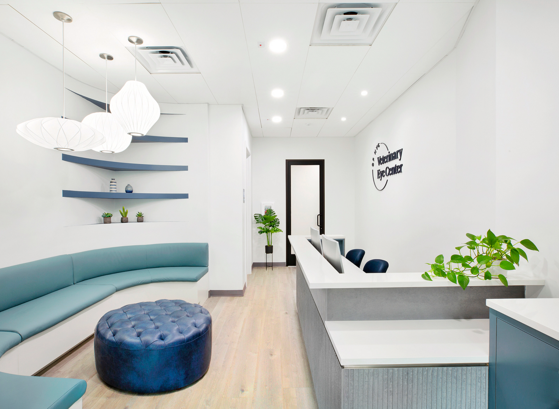 There is a blue ottoman in the middle of the room.