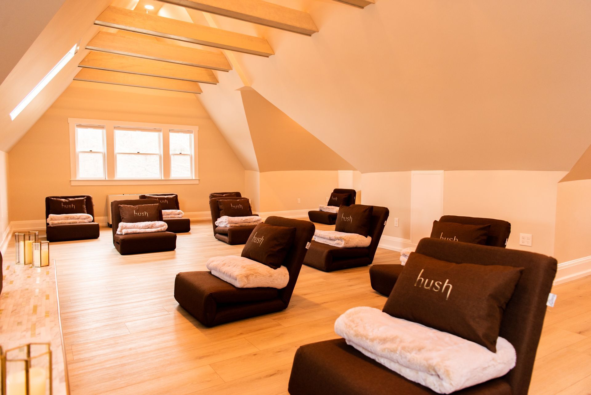 a room with a lot of chairs and a pillow that says lush