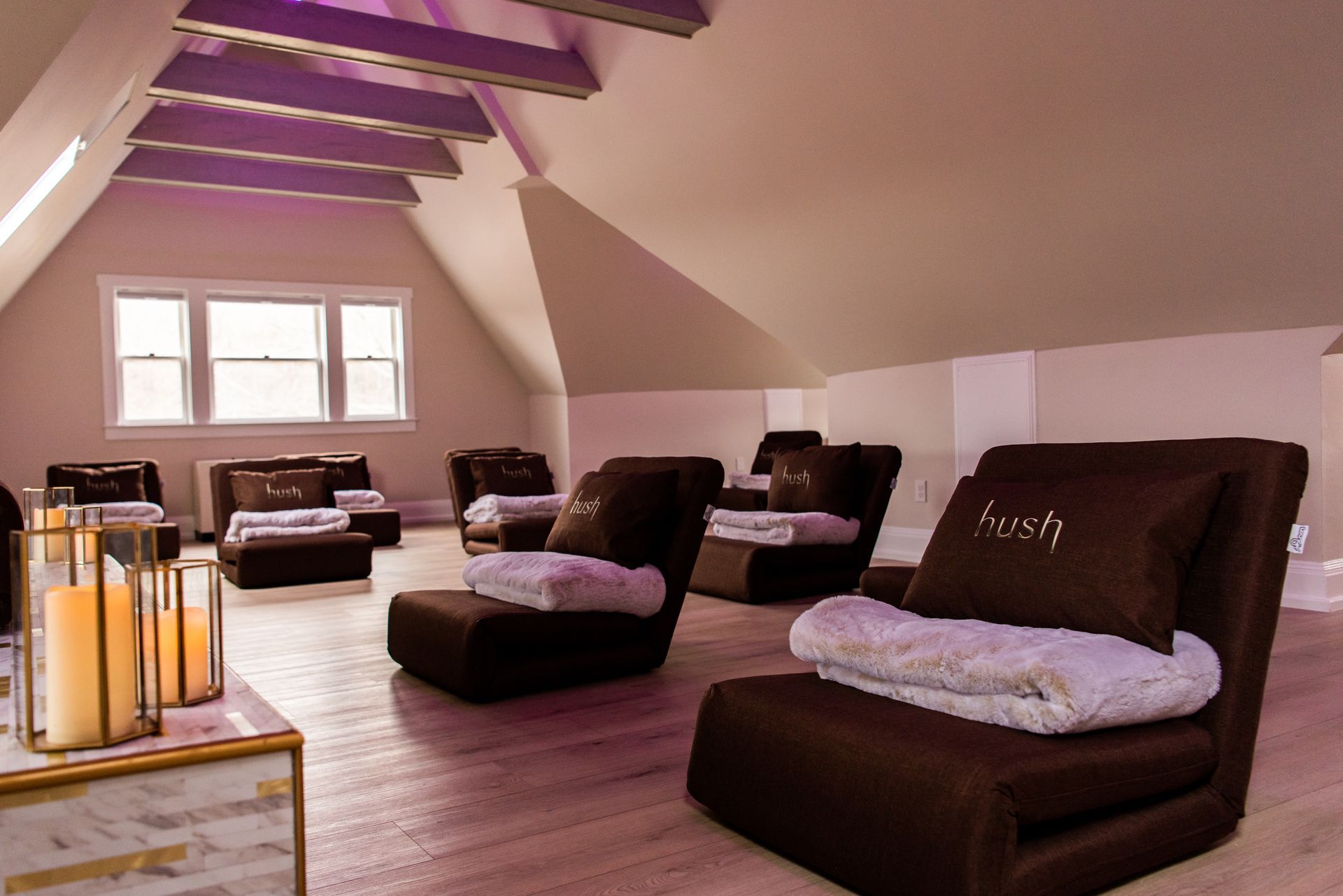 a room with a lot of chairs and a candle holder