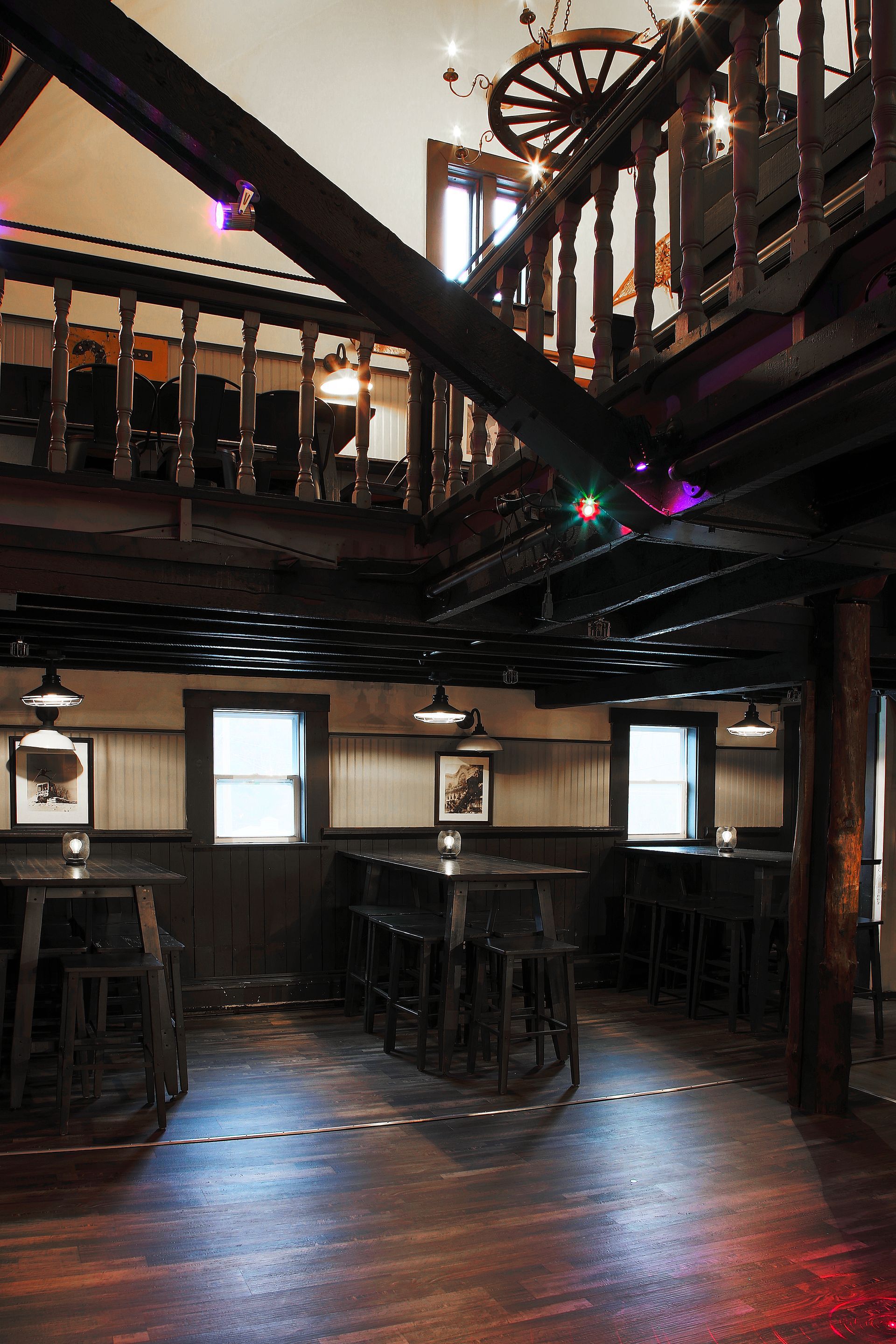 A large room with tables and chairs and a balcony