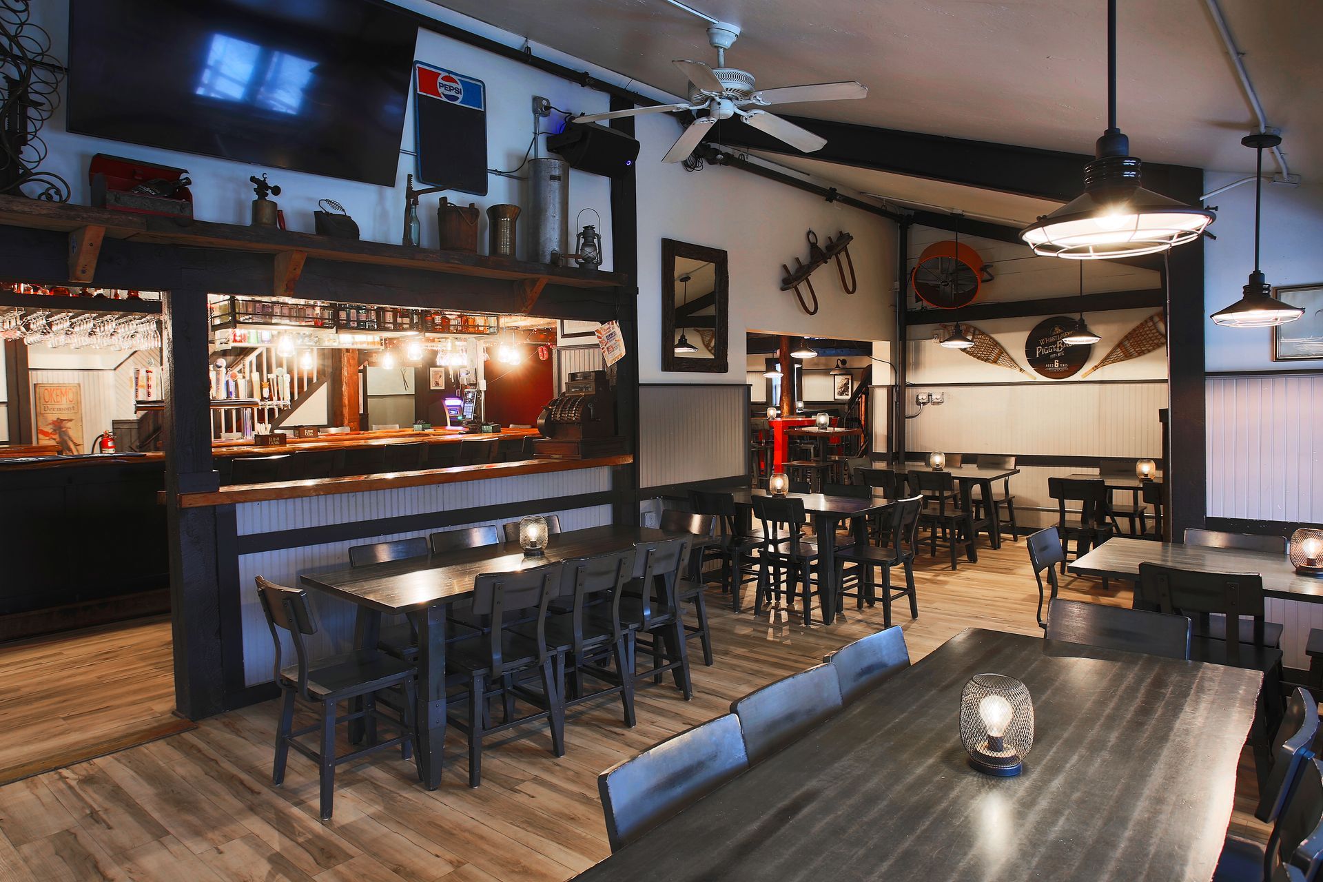 A large dining room with tables and chairs and a bar