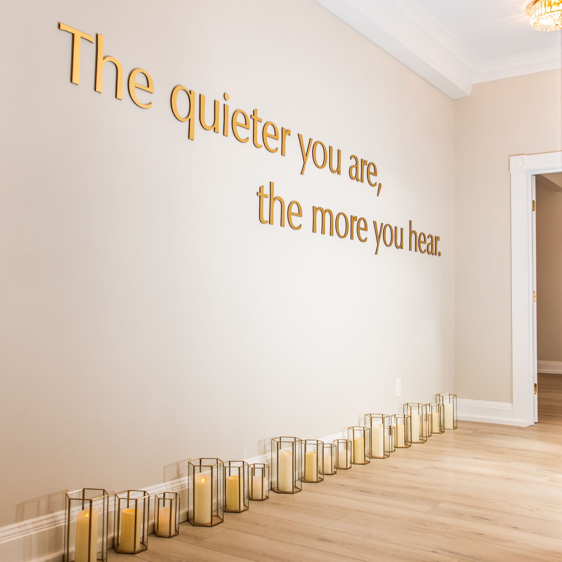 a wall with a quote on it that says the quieter you are the more you hear