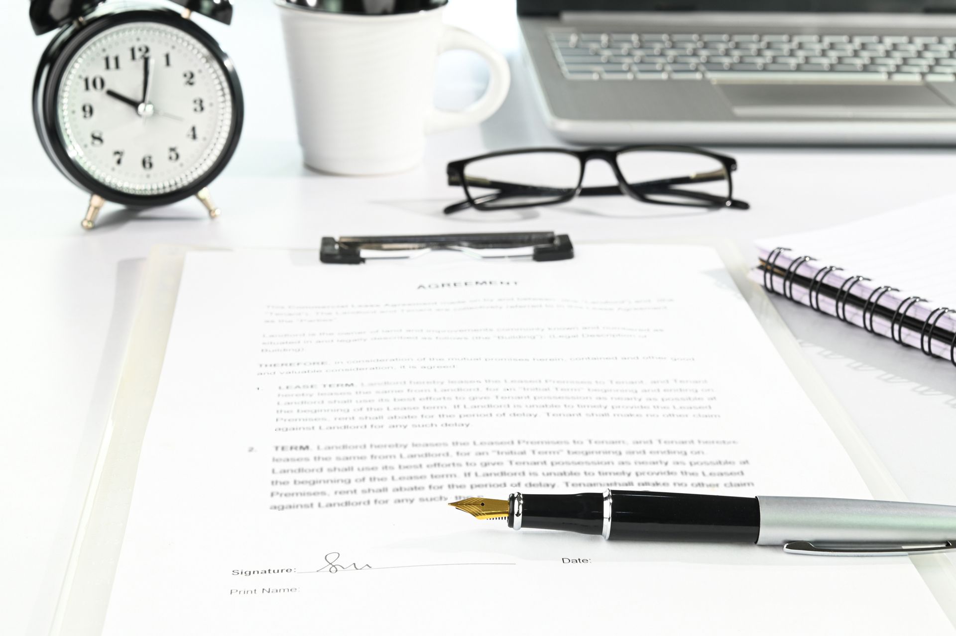 An agreement contract on a crowded desk.