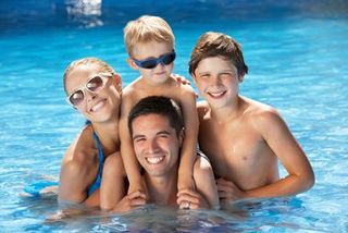 Family relaxing in the pool — Pool Cleaning and Maintenance in Gettysburg, PA