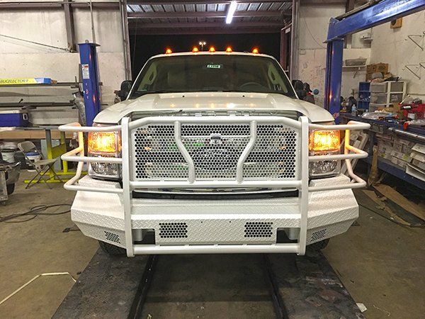 newly installed grille on a white Ford truck