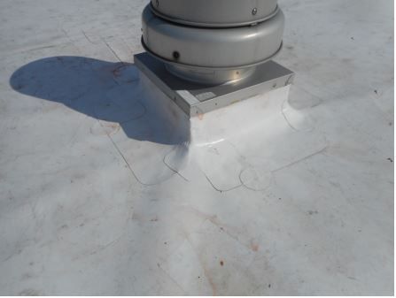 White flat roof with vent pipe and flashing.
