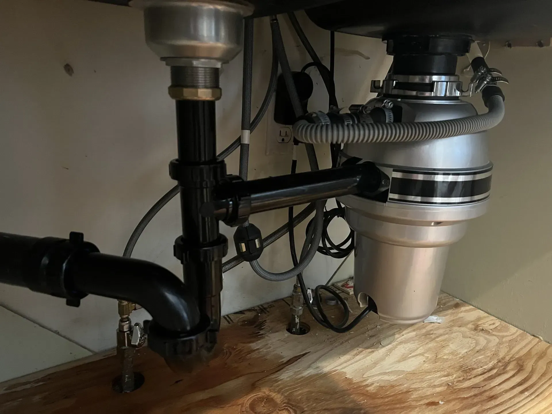 A sink with a garbage disposal underneath it