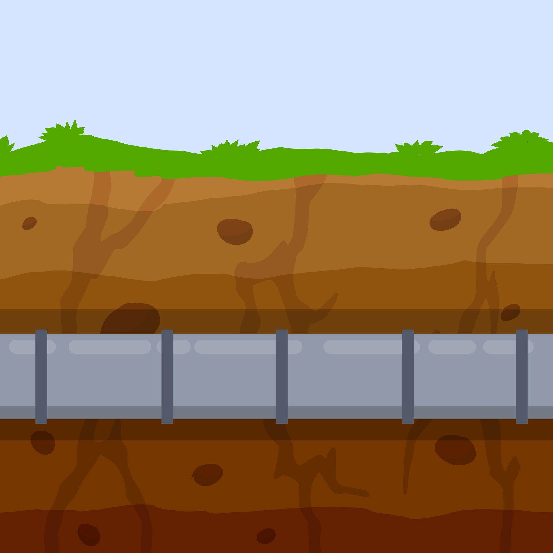 A bunch of pipes are laying in the dirt