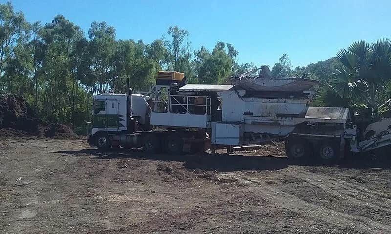 A Large White Truck Is Parked In A Dirt Field — Chop N Chip Tree Fellas In Roseneath, QLD
