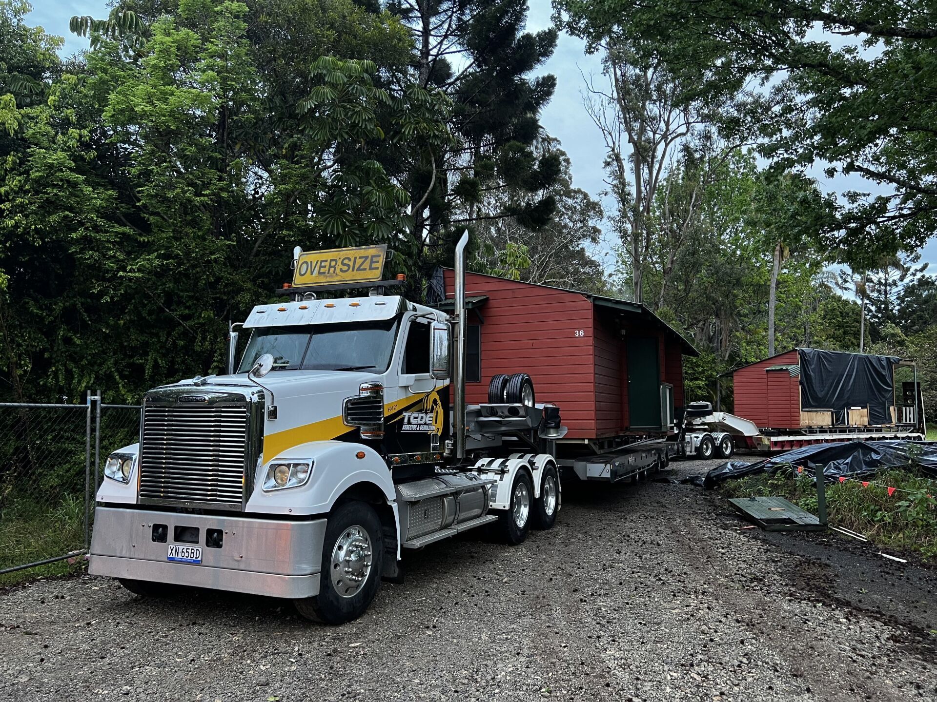 Big Truck Carrying a Red Shed — Asbestos Removal And Demolition in Northern Rivers, NSW