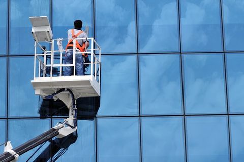 Commercial Window Washing — Window Cleaner Working on a Glass Facade in Pittsburgh, PA