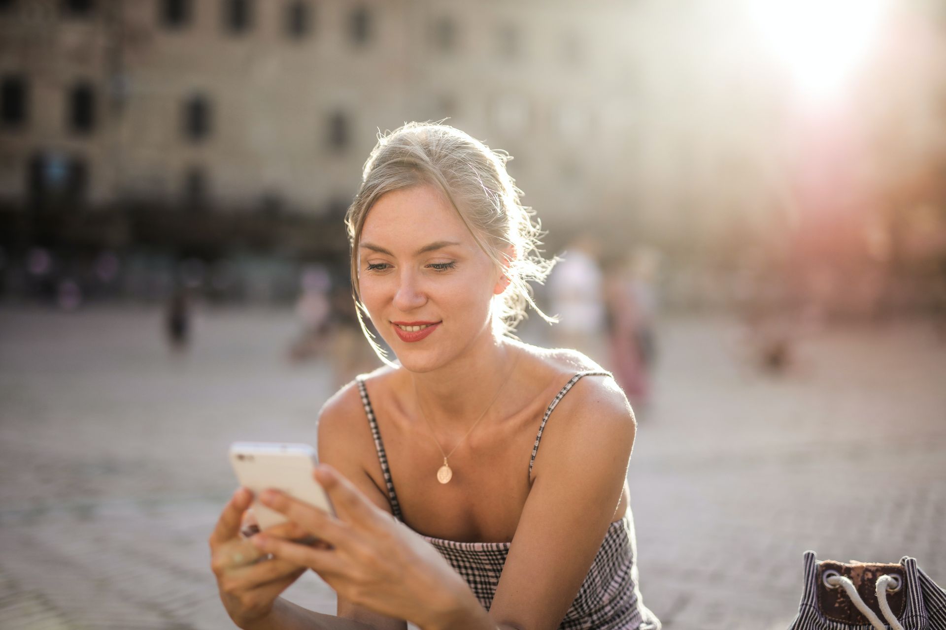 young blonde woman on cell phone in city center
