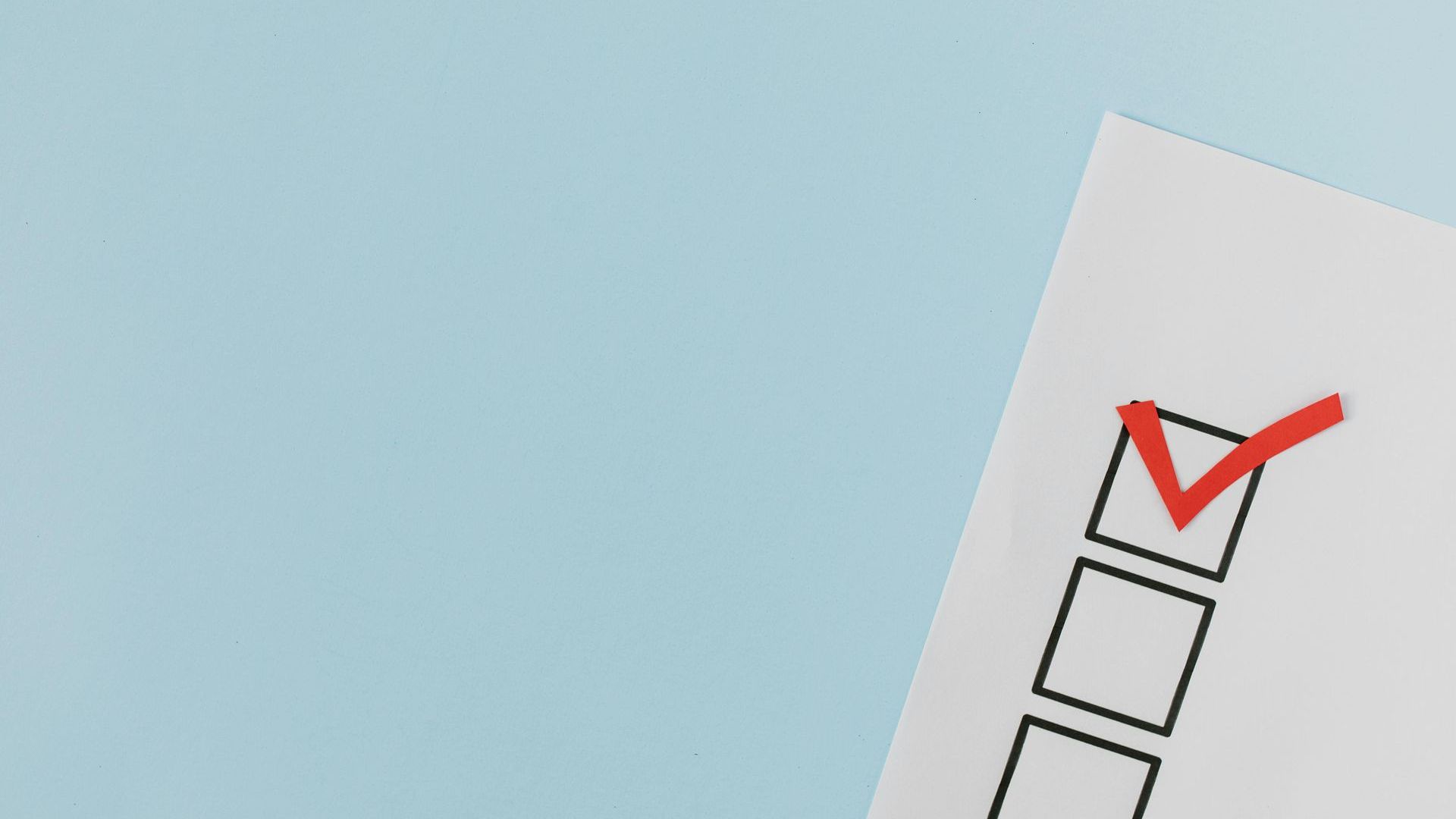 A checklist with a red check mark on a blue background.