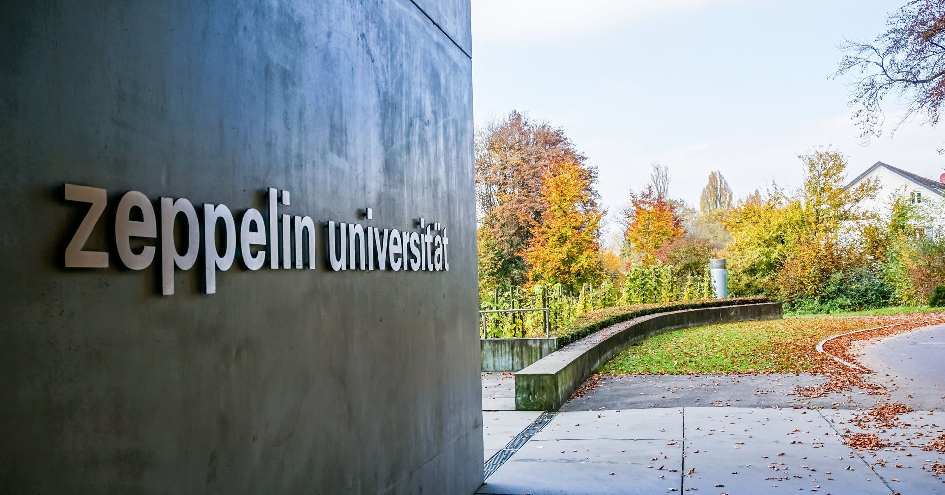 A sign on a wall that says Zeppelin University.