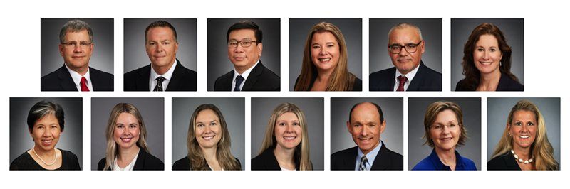 Eight professional headshots in two rows on a gray background, with black suits and smiling expressions.