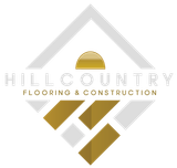 A logo for hill country flooring and construction