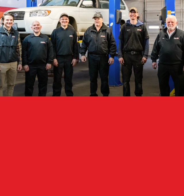 A group of men standing in front of a white truck | D&W Auto Repair