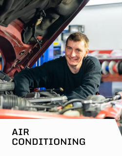 A man is working on a car with the hood open | D&W Auto Repair