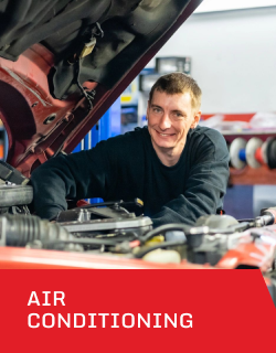 A man is working on a car with the hood open | D&W Auto Repair