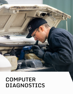 A man is working under the hood of a car with the words computer diagnostics below him | D&W Auto Repair