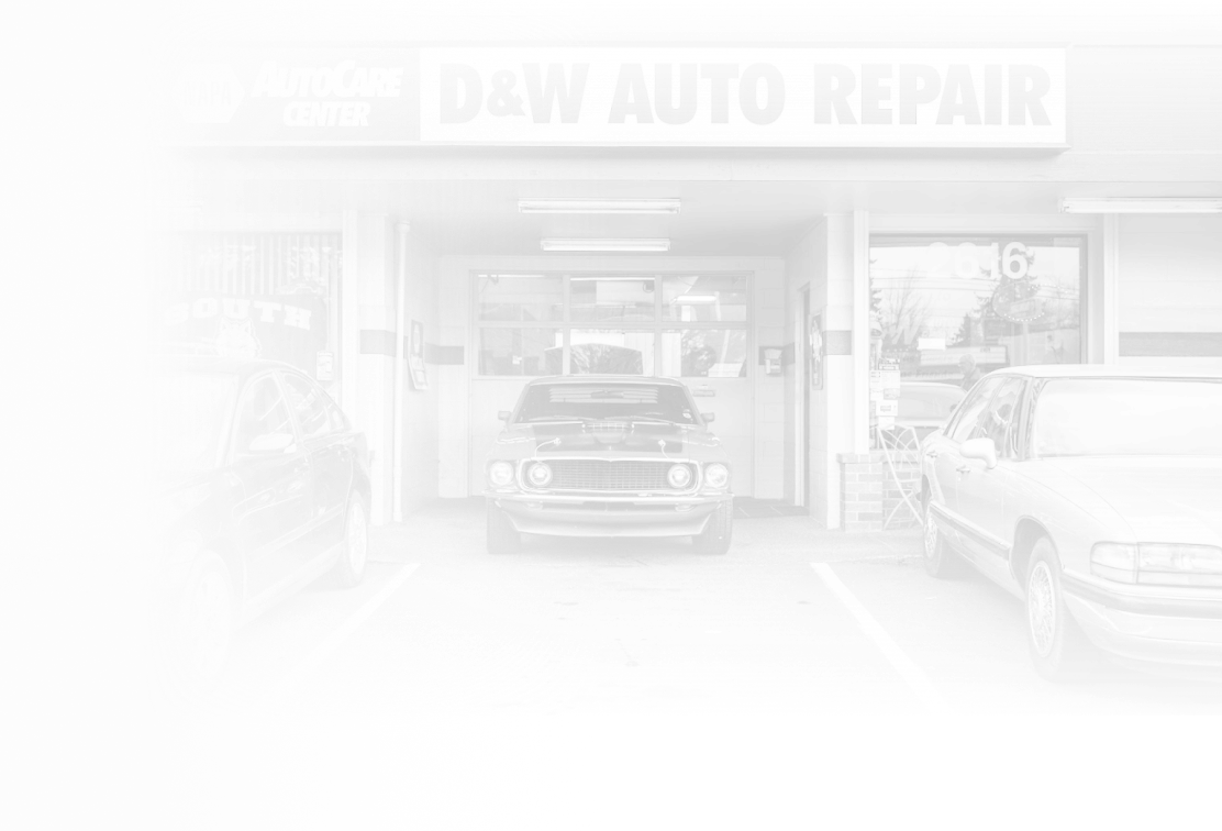 A car is parked in front of a car repair shop. | D&W Auto Repair