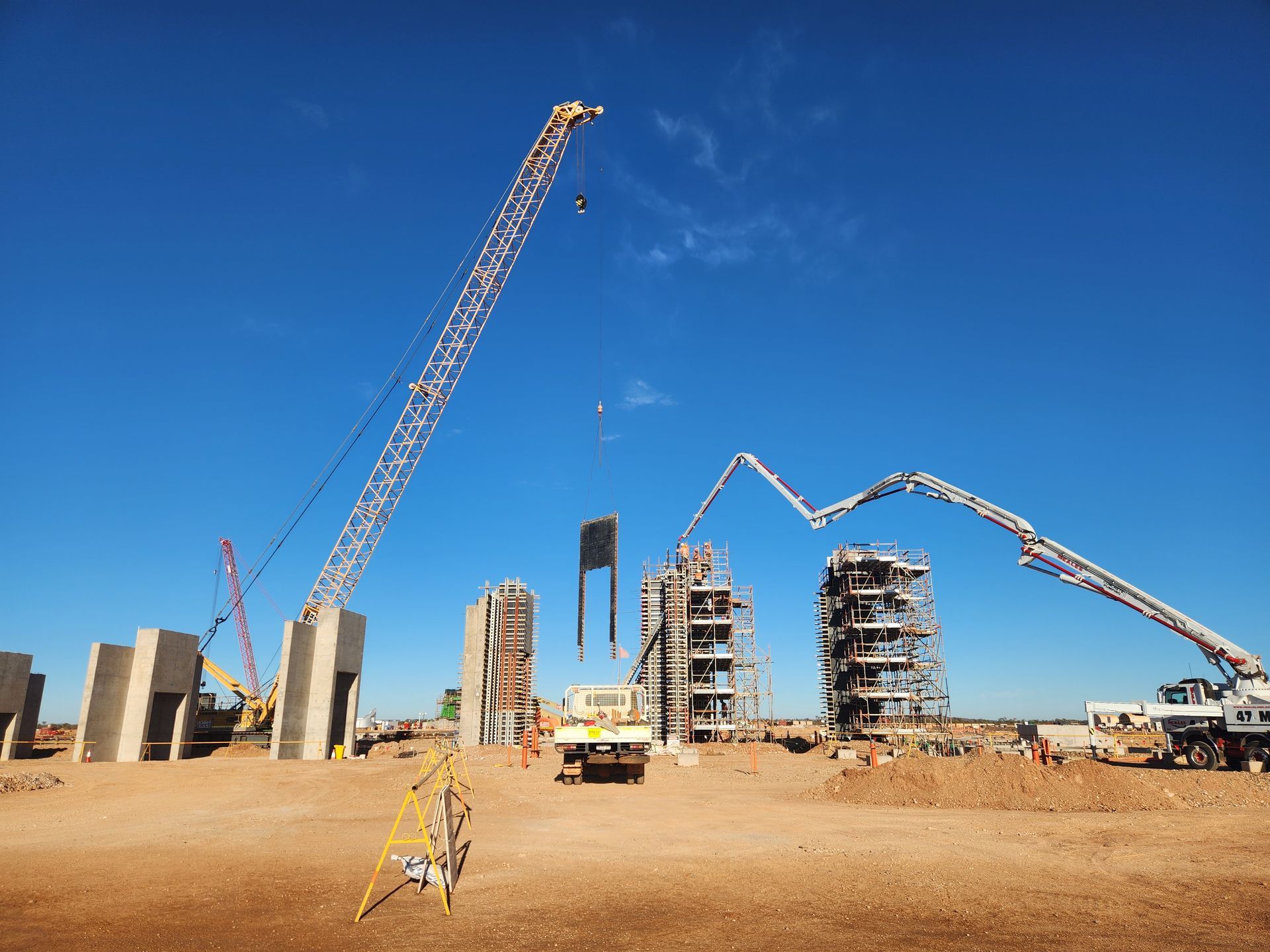 Large yellow bucket-wheel excavator in a barren landscape, working on a mine.