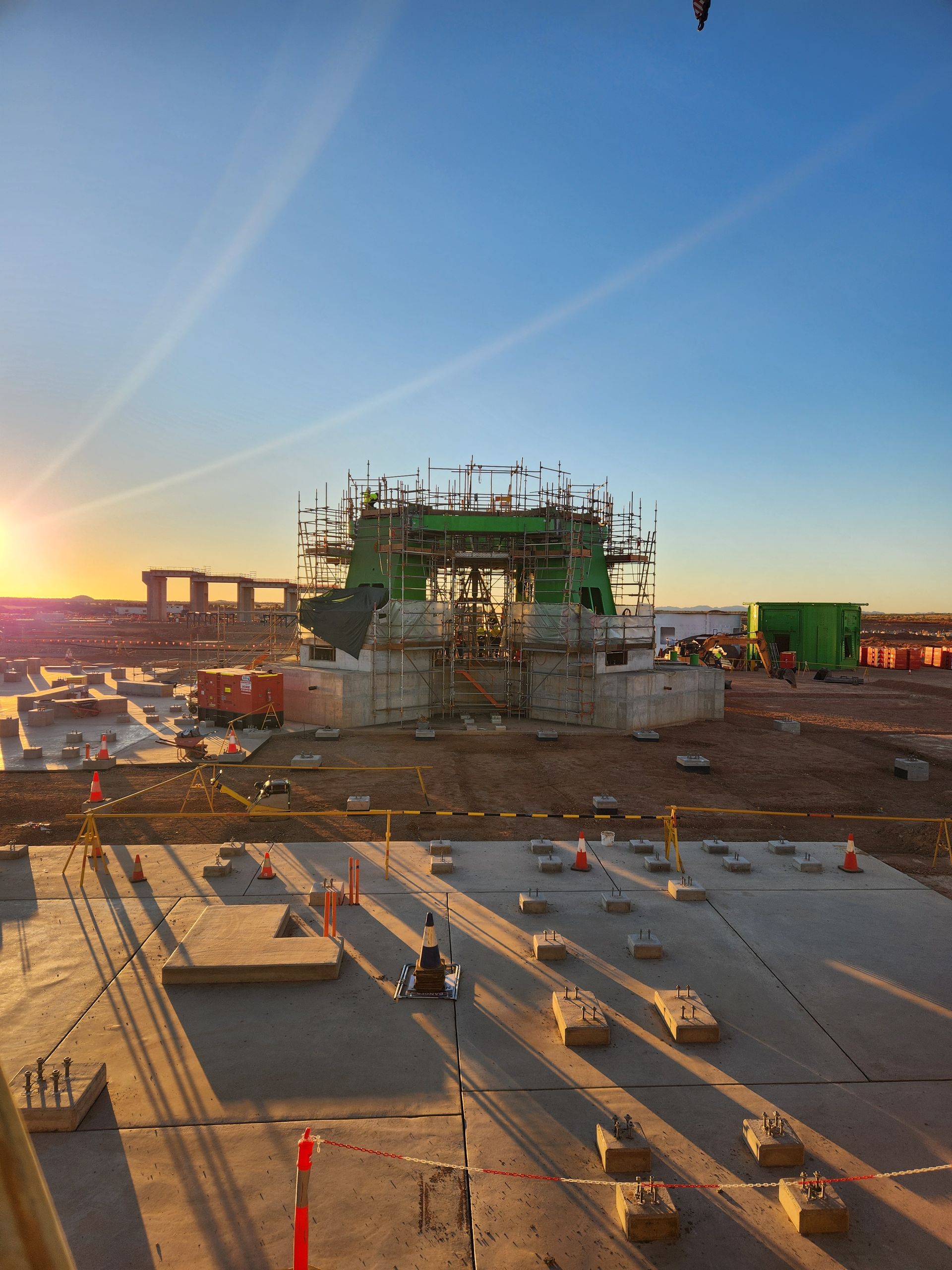 Large yellow bucket-wheel excavator in a barren landscape, working on a mine.