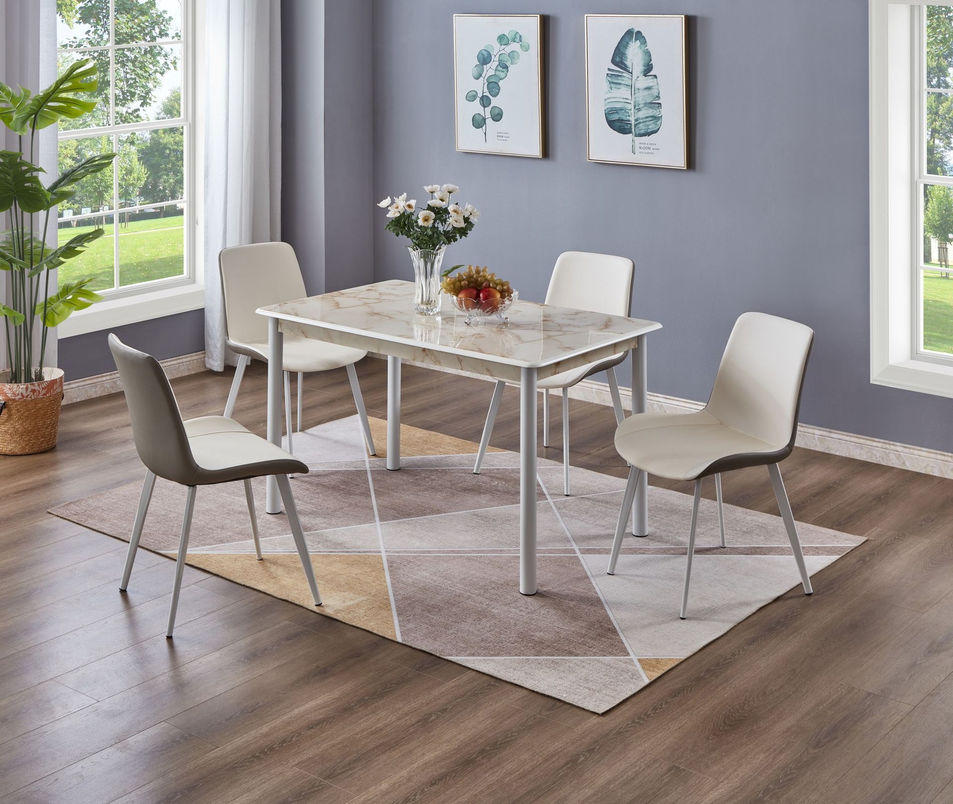 Dining room with a marble-top table, four chairs, and a patterned rug. Two paintings hang on a wall.