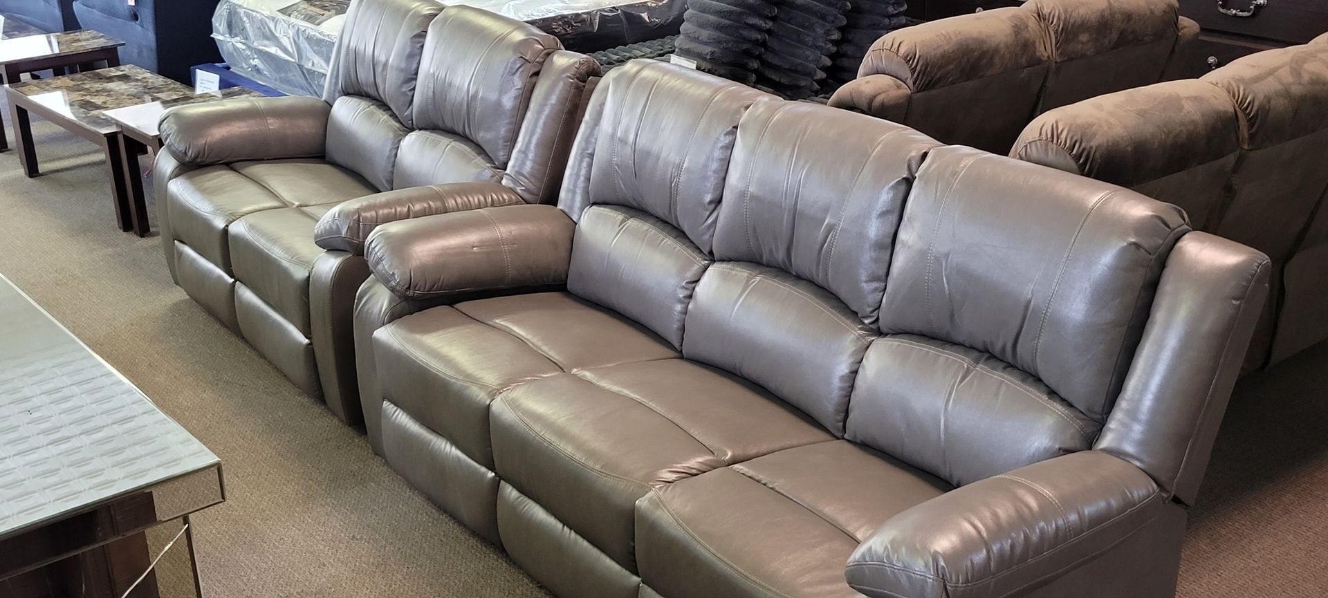 Gray leather sofas in a showroom.