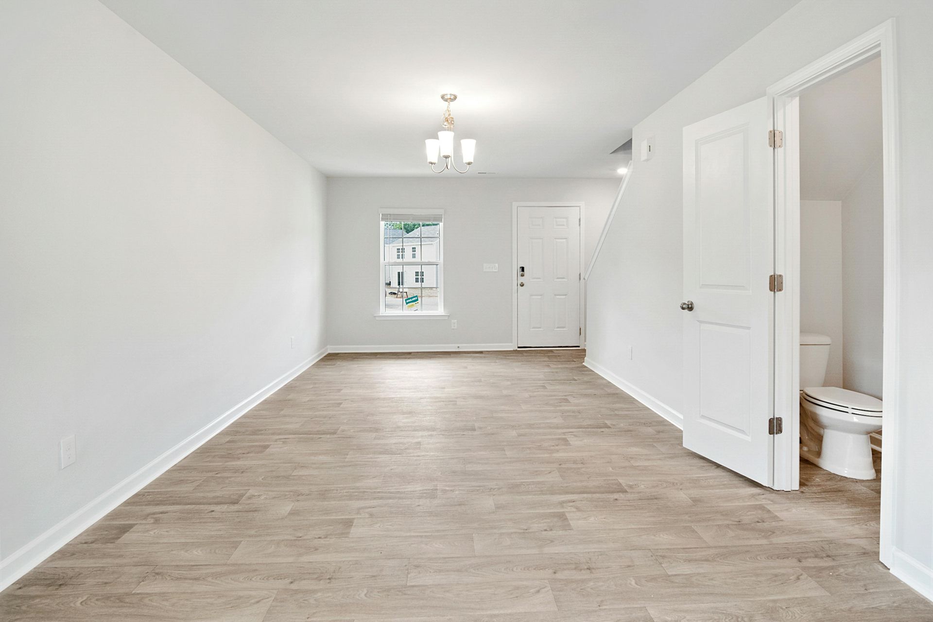 An empty room with a toilet and a window